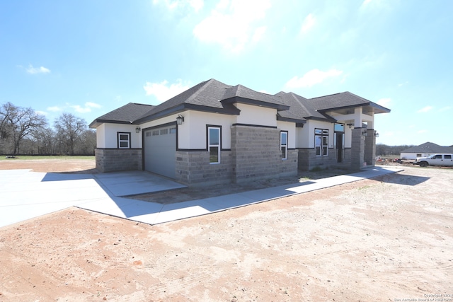 prairie-style home featuring a garage