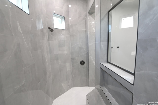 bathroom with a tile shower