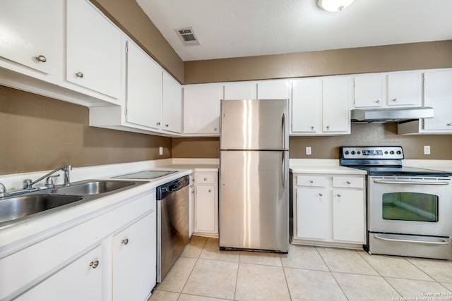 kitchen featuring white cabinets, appliances with stainless steel finishes, light tile patterned floors, and sink