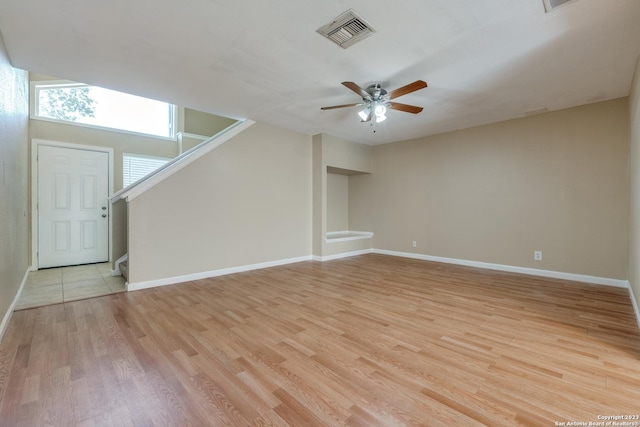 unfurnished living room with ceiling fan and light hardwood / wood-style floors