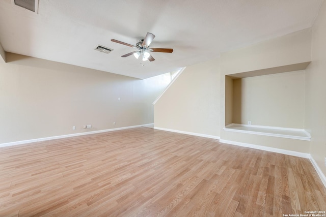 additional living space with light wood-type flooring and ceiling fan