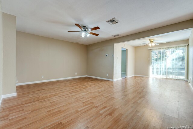 empty room featuring ceiling fan and light hardwood / wood-style flooring