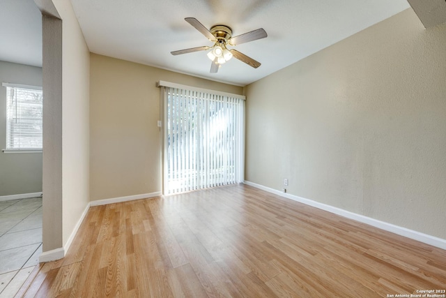 empty room with light hardwood / wood-style floors and ceiling fan