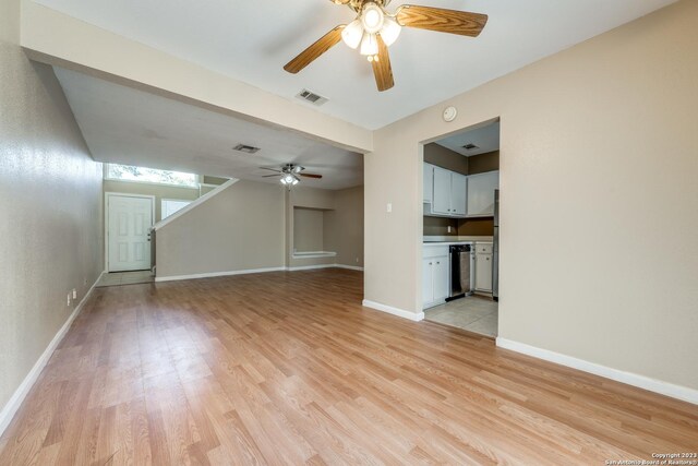 unfurnished living room featuring ceiling fan and light wood-type flooring