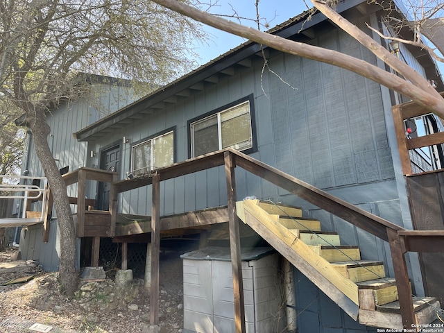 view of side of home with a wooden deck