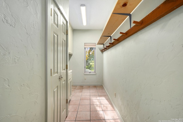 hallway featuring light tile patterned flooring