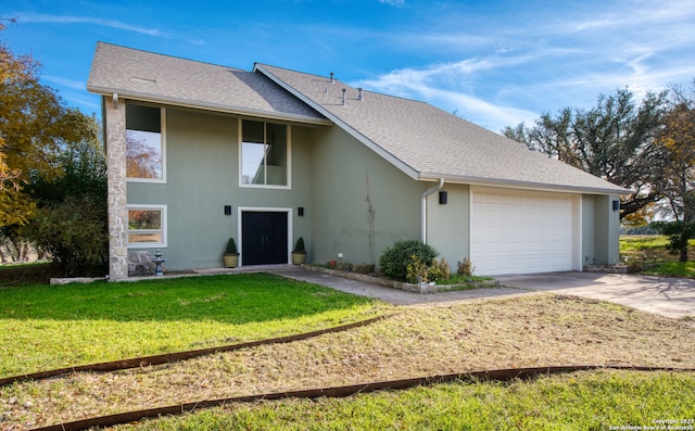 ranch-style house featuring a garage and a front lawn