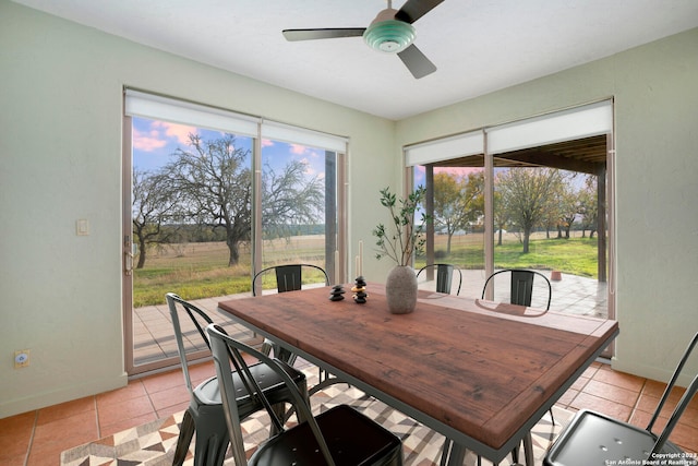 dining area with light tile patterned flooring and ceiling fan