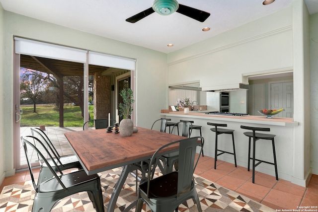 tiled dining room featuring sink and ceiling fan