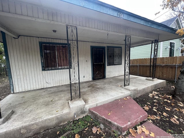 view of exterior entry with a porch