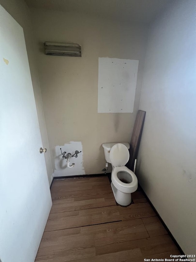 bathroom featuring toilet and hardwood / wood-style floors