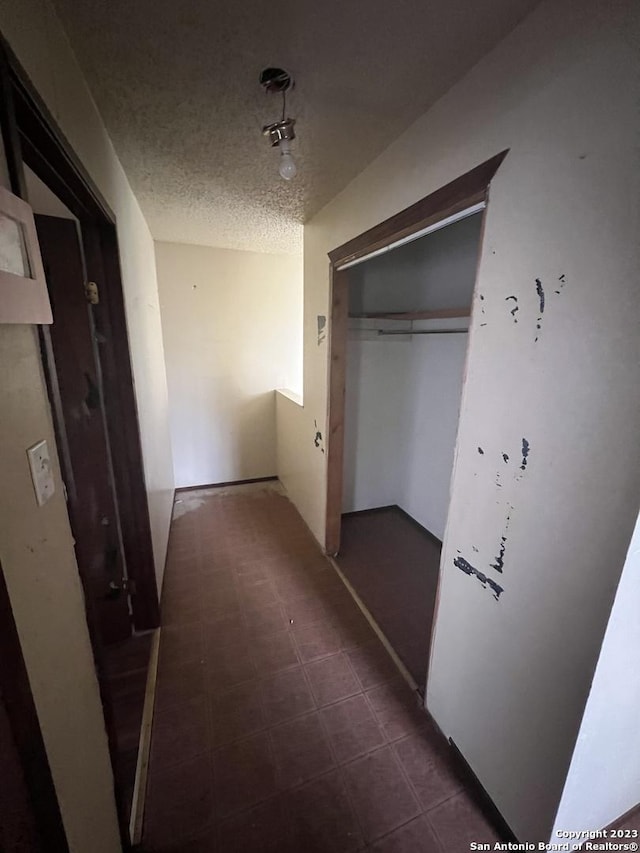 hallway featuring a textured ceiling