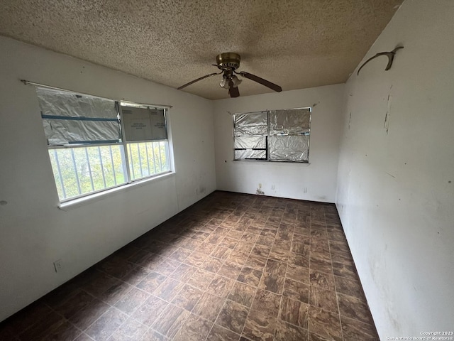 unfurnished room featuring a textured ceiling and ceiling fan