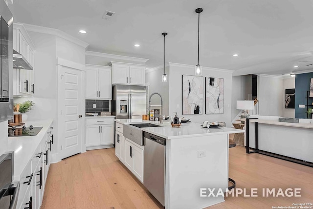 kitchen featuring appliances with stainless steel finishes, light hardwood / wood-style floors, a kitchen island with sink, and white cabinets