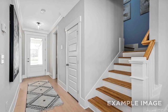 foyer featuring light hardwood / wood-style flooring and ornamental molding