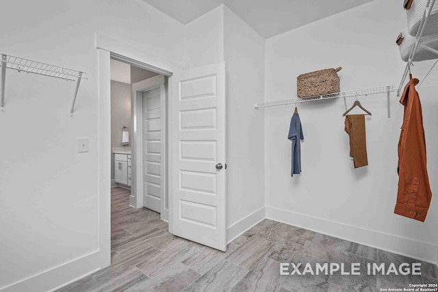 spacious closet with light hardwood / wood-style flooring