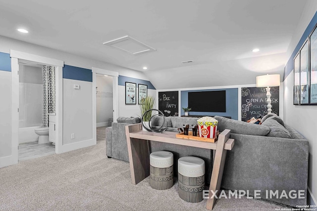 living room with light carpet and vaulted ceiling