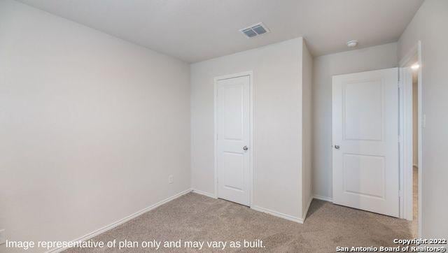 unfurnished bedroom featuring light carpet