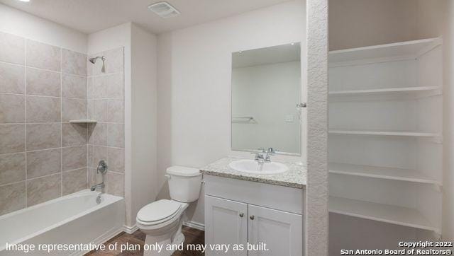 full bathroom with vanity, toilet, and tiled shower / bath