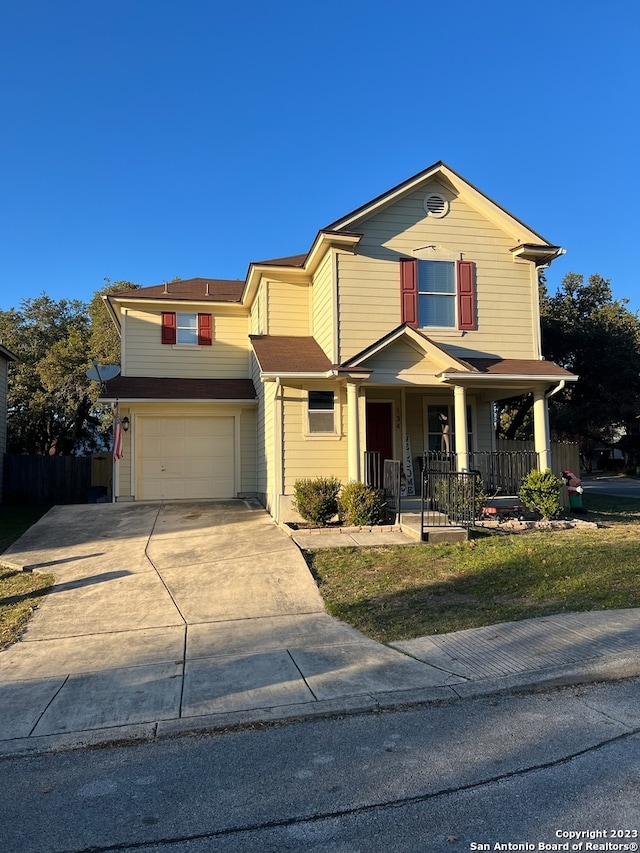 view of front of house with covered porch and a garage