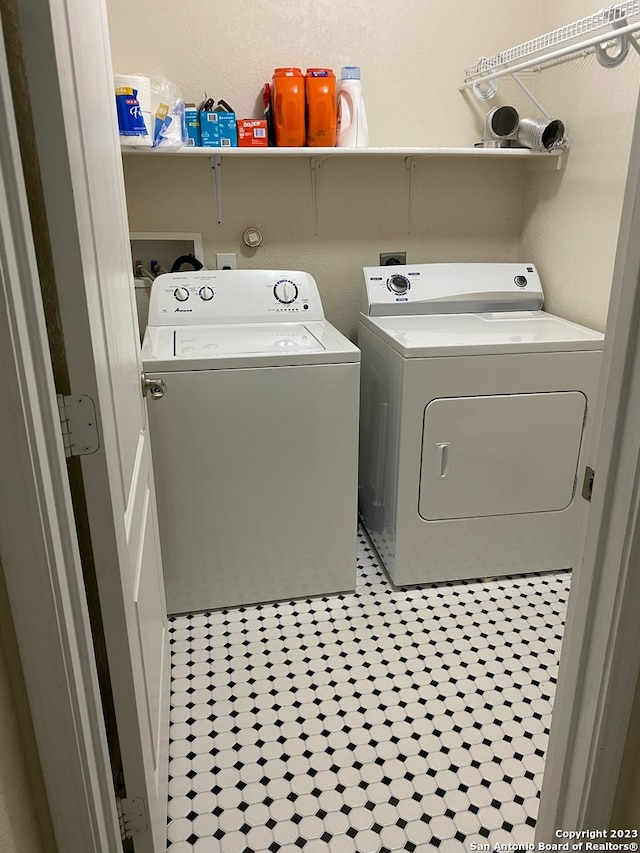 laundry room featuring light tile patterned floors and separate washer and dryer