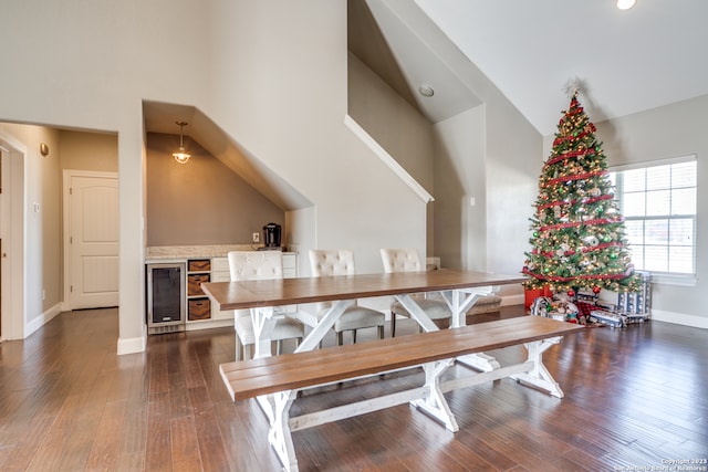 dining space featuring dark hardwood / wood-style floors and lofted ceiling