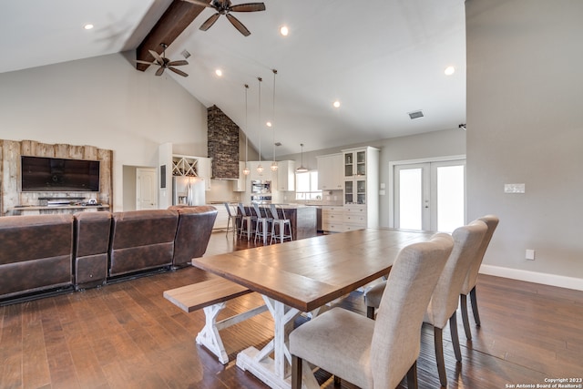 dining area featuring beam ceiling, french doors, dark hardwood / wood-style flooring, ceiling fan, and high vaulted ceiling