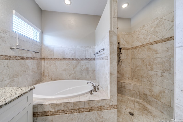 bathroom featuring vanity and plus walk in shower