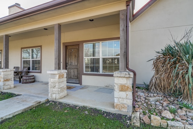 property entrance featuring a porch