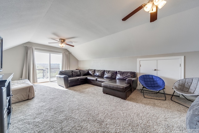 carpeted living room featuring a textured ceiling, lofted ceiling, and ceiling fan