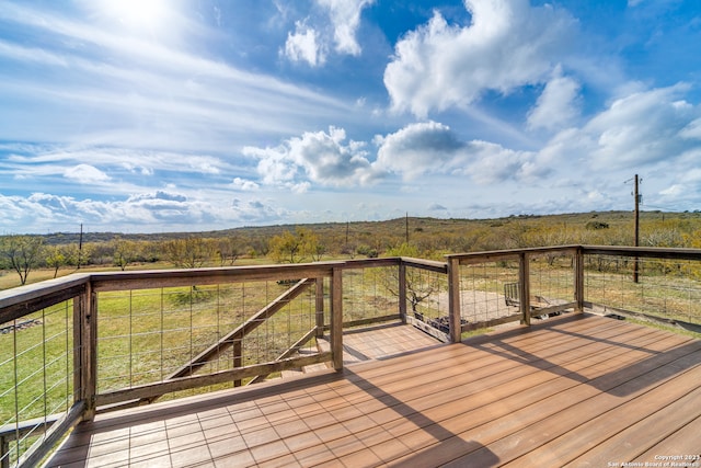 wooden terrace featuring a rural view