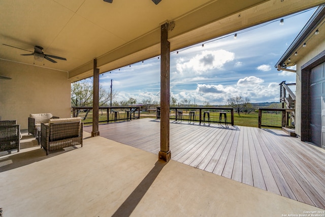 wooden deck featuring ceiling fan