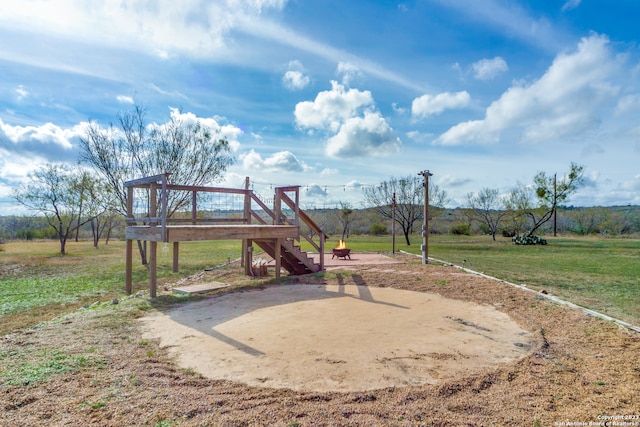 view of jungle gym with a lawn and a wooden deck