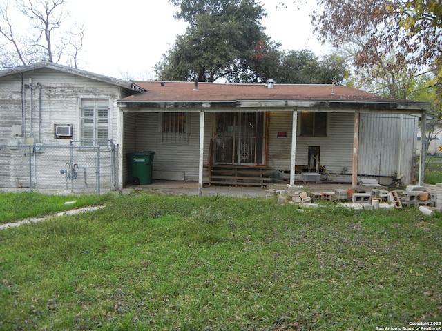 back of property featuring a lawn