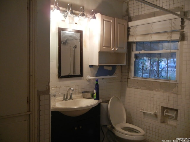 bathroom featuring tile walls, toilet, decorative backsplash, and vanity