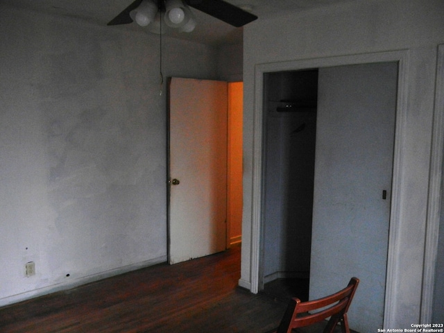 unfurnished bedroom with a closet, ceiling fan, and dark hardwood / wood-style floors