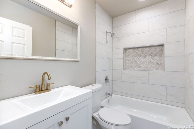 full bathroom featuring vanity, tiled shower / bath combo, and toilet