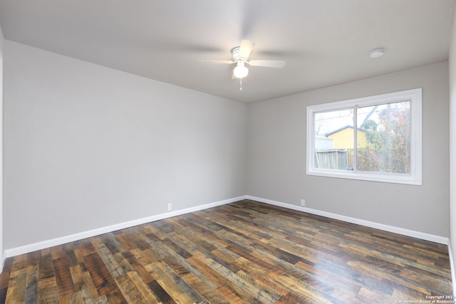 spare room featuring dark hardwood / wood-style floors and ceiling fan