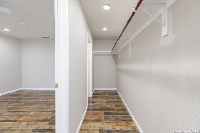 spacious closet featuring dark hardwood / wood-style flooring