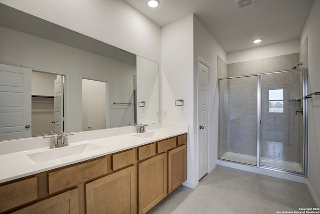 bathroom with tile patterned floors, vanity, and an enclosed shower