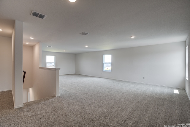 unfurnished room with plenty of natural light and light colored carpet