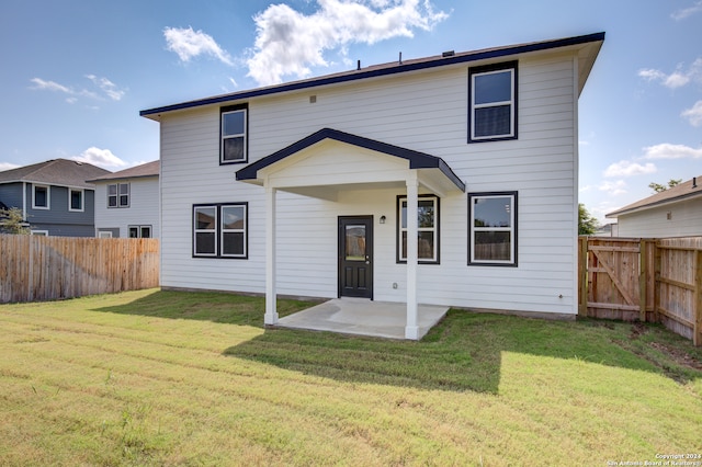 back of property featuring a yard and a patio