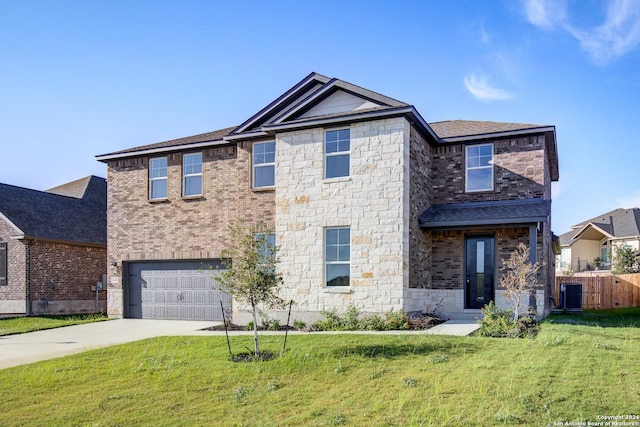 view of front of property featuring cooling unit, a garage, and a front yard