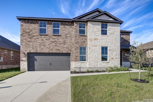 view of front of house featuring a front lawn and a garage