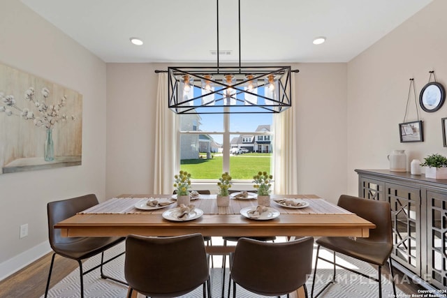 dining room with a chandelier and hardwood / wood-style floors