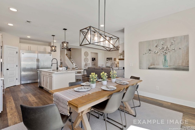 dining space featuring dark wood-type flooring and sink