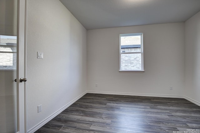 empty room with dark wood-type flooring