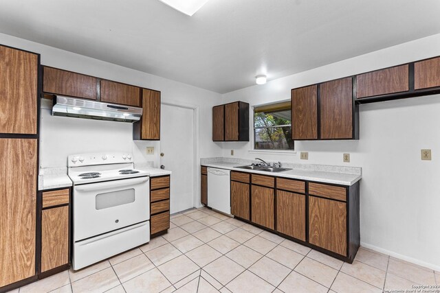 kitchen with sink, white appliances, and light tile patterned floors