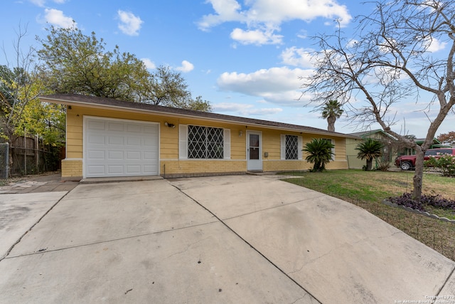 single story home featuring a garage and a front yard