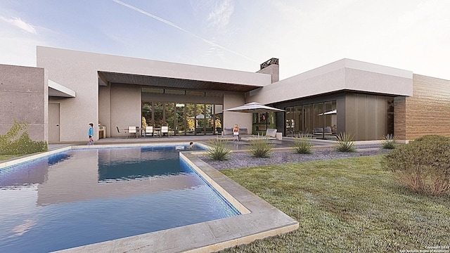 view of pool with a lawn and a patio